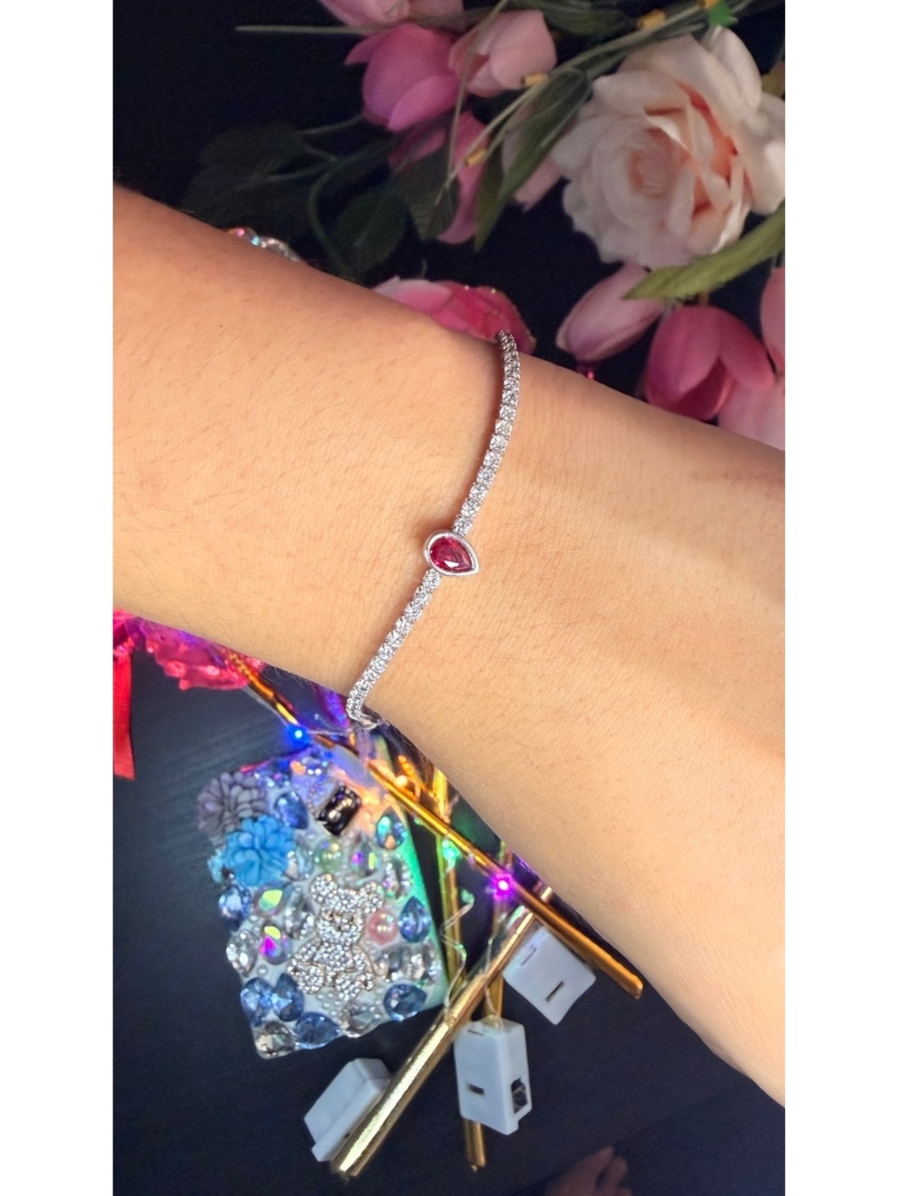 Elegant Silver Tennis Bracelet with Pear-Shaped Ruby Centerpiece